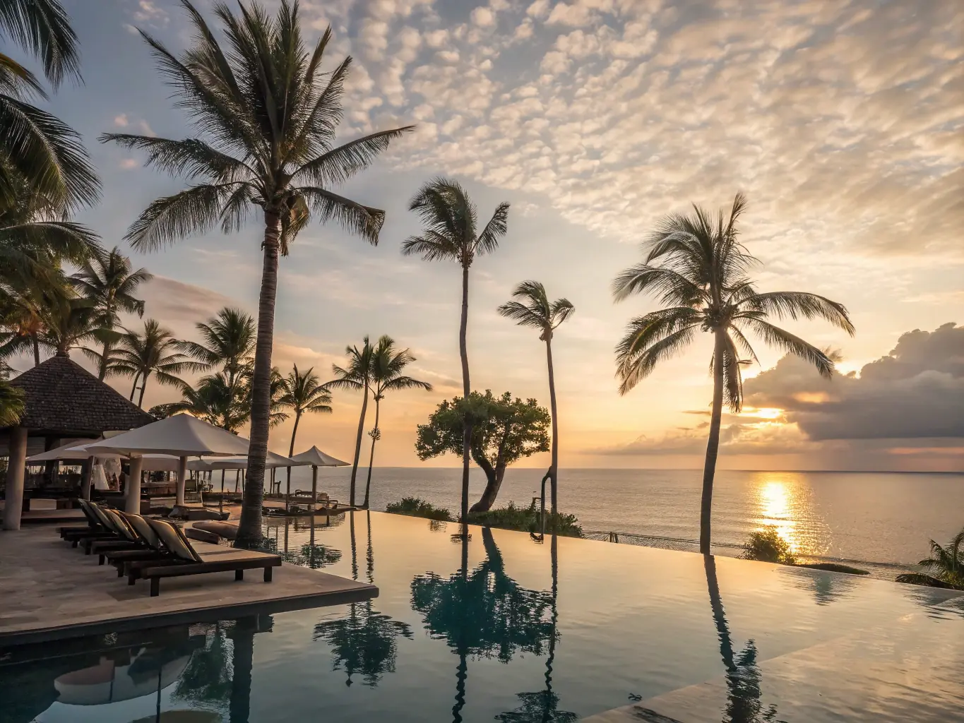 A luxurious resort in Costa Rica with an infinity pool overlooking the Pacific Ocean at sunset, highlighting elegance, comfort, and stunning natural beauty.